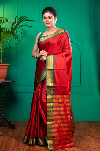 Red aura silk saree with contrasting green and golden zari borderwith running blouse piece