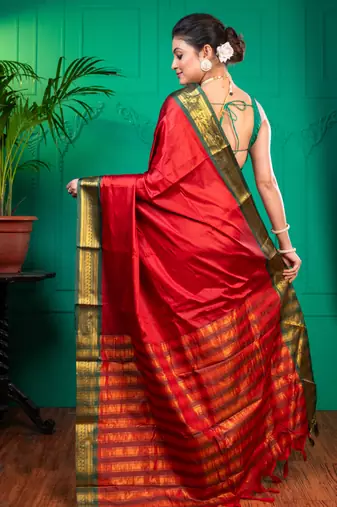 Red aura silk saree with contrasting green and golden zari borderwith running blouse piece