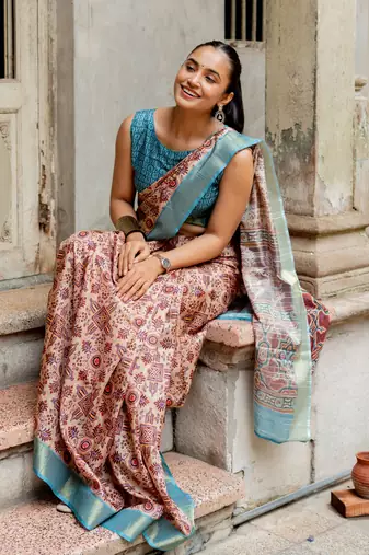 Light peach silk blend ajrakh print golden zari border saree
