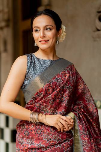 Maroon silk blend ajrakh print golden zari border saree