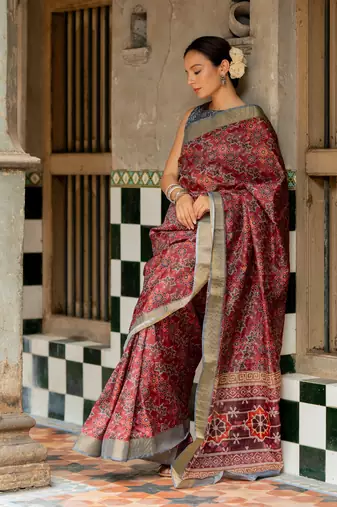 Maroon silk blend ajrakh print golden zari border saree