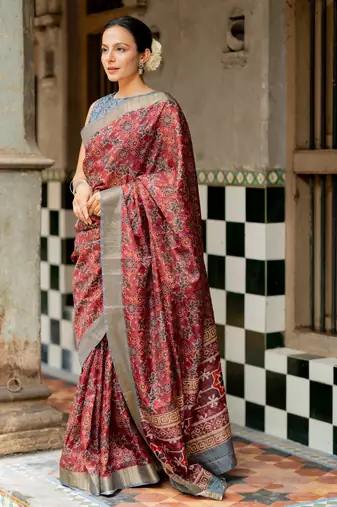 Maroon silk blend ajrakh print golden zari border saree
