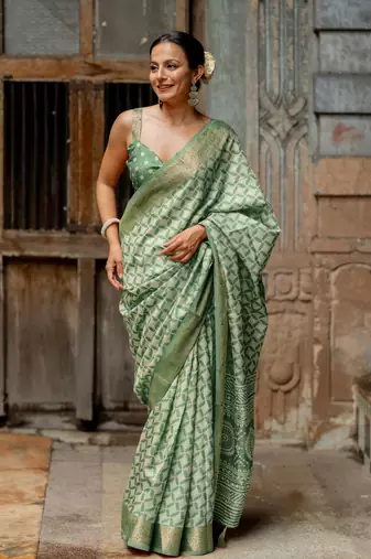 Dusty green silk blend geometric print golden woven border saree