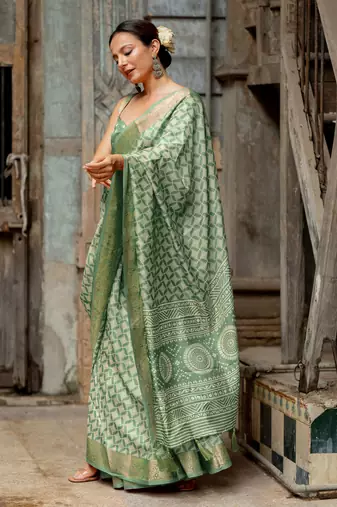 Dusty green silk blend geometric print golden woven border saree