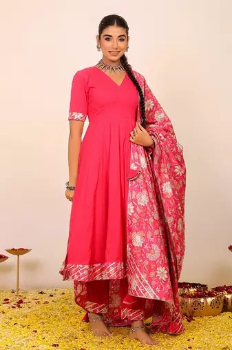 Rani pink solid anarkali suit set paired with pant and printed dupatta
