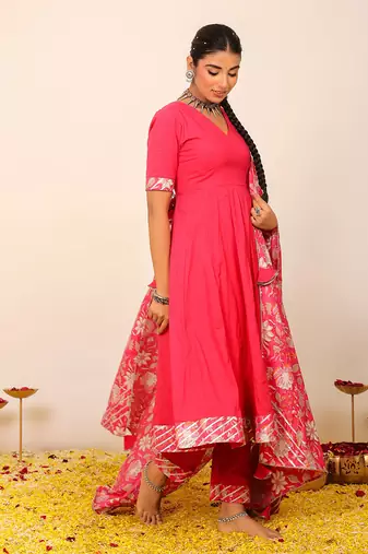 Rani pink solid anarkali suit set paired with pant and printed dupatta