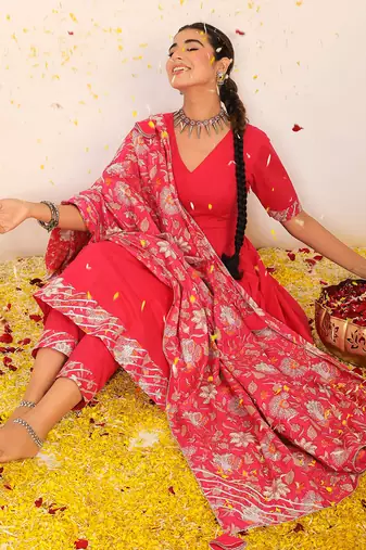 Rani pink solid anarkali suit set paired with pant and printed dupatta