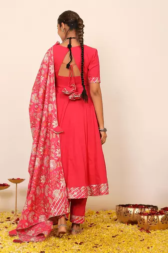 Rani pink solid anarkali suit set paired with pant and printed dupatta