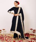 Solid black velvet anarkali kurta paired with pant and dupatta