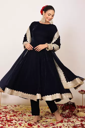 Solid black velvet anarkali kurta paired with pant and dupatta