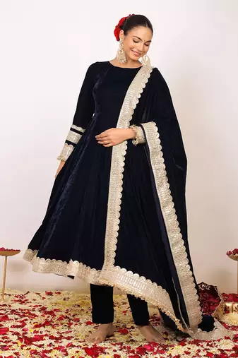 Solid black velvet anarkali kurta paired with pant and dupatta