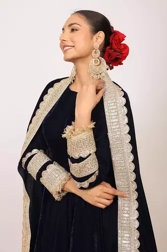 Solid black velvet anarkali kurta paired with pant and dupatta