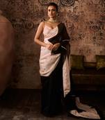 Peach embroidered blouse with black and peach colour block saree