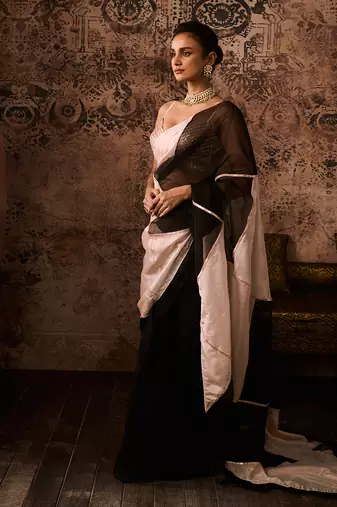 Peach embroidered blouse with black and peach colour block saree