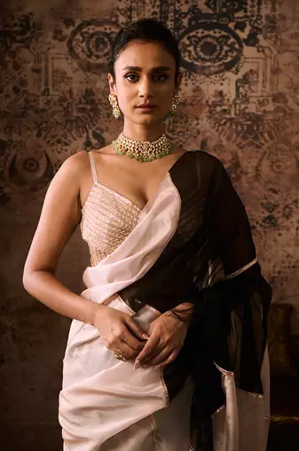 Peach embroidered blouse with black and peach colour block saree