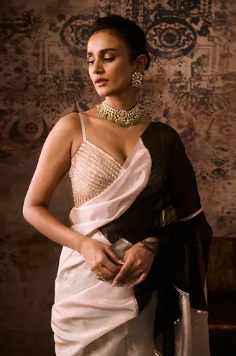 Peach embroidered blouse with black and peach colour block saree