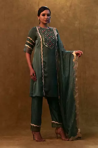 Emerald green kurta set paired with pants and organza dupatta
