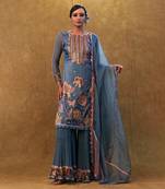 Blue applique work kurta set paired with flared sharara and a dupatta.