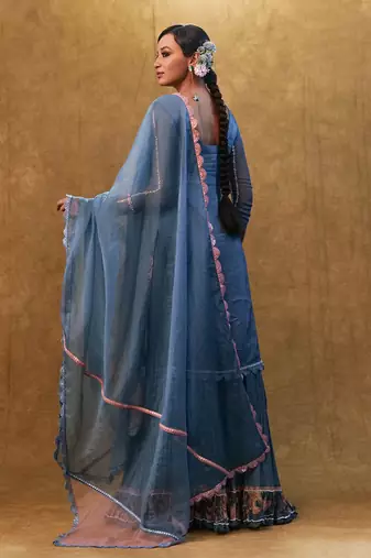 Blue applique work kurta set paired with flared sharara and a dupatta.