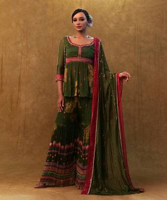 Green printed sharara set paired with color block dupatta and a peplum. 1