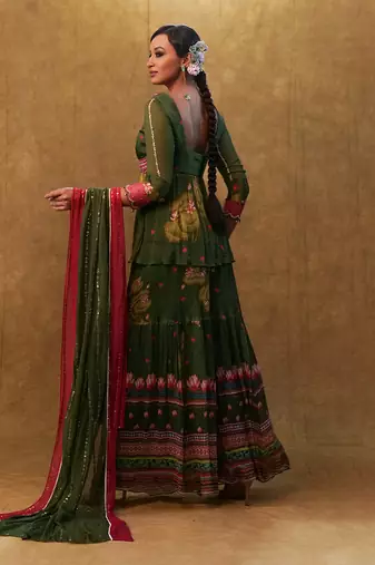 Green printed sharara set paired with color block dupatta and a peplum.