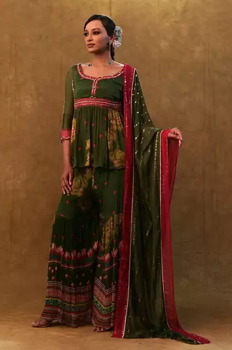 Green printed sharara set paired with color block dupatta and a peplum.
