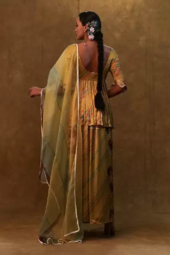 Mustard printed peplum set paired with dupatta and pants
