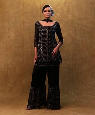 Black kurta set paired with fringe dupatta and flared pants 1