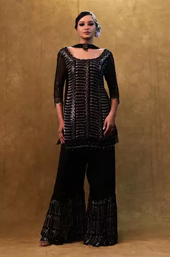 Black kurta set paired with fringe dupatta and flared pants