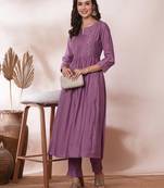 Pocketed a line kurta adorned with zari embroidery and paired with lined silk blend pants.