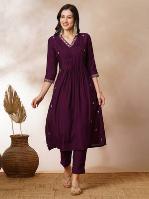 A-line pocketed silk blend kurta with zari embroidery and pleat detailing paired with lined pants. 1
