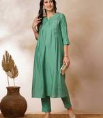Pleated a-line silk blend kurta with embroidery and pocket, paired with lined silk blend pants.