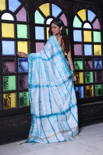 All over foliage embroidery white and sky blue silk saree with chanderi borders