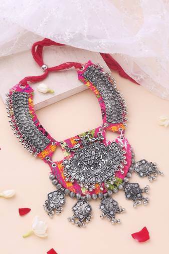 Oxidised statement necklace with work on vibrant pink fabric