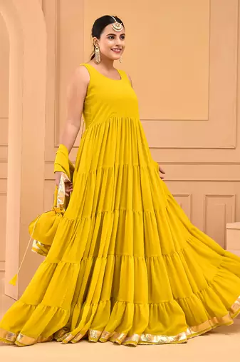 Mustard floor length tiered anarkali  paired with dupatta and potli bag