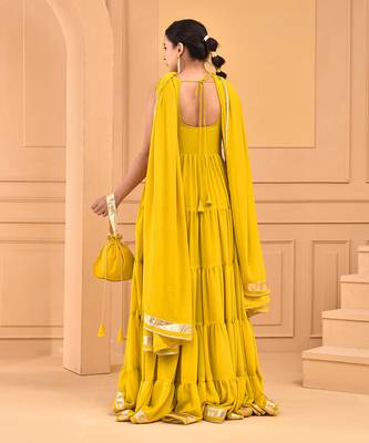 Mustard floor length tiered anarkali  paired with dupatta and potli bag 4