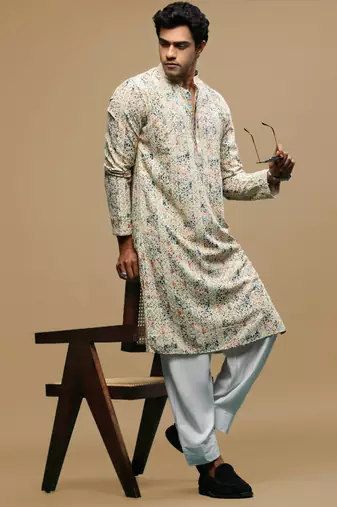 Sanwara men's printed orange & blue chikankari kurta & salwar set with sequin accents.