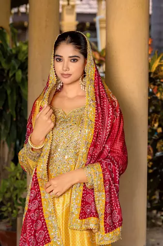 Yellow chinon bandhani printed heavy salwar kameez with jari and mirror embroidery work