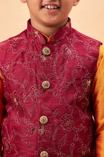 maroon nehru jacket and orange kurta and pyjama set