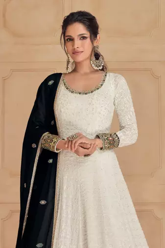 White embroidered georgette free size stitched gown.
