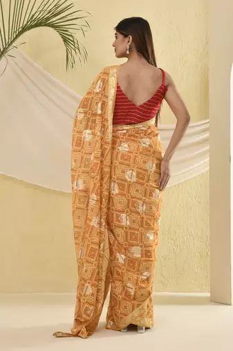 Yellow bandhani and zari work saree with unstitched blouse fabric