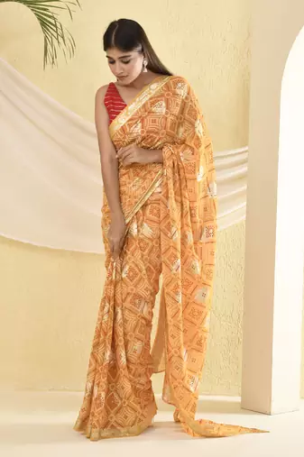 Yellow bandhani and zari work saree with unstitched blouse fabric