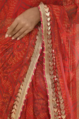 Red bandhani worked saree with unstitched blouse fabric