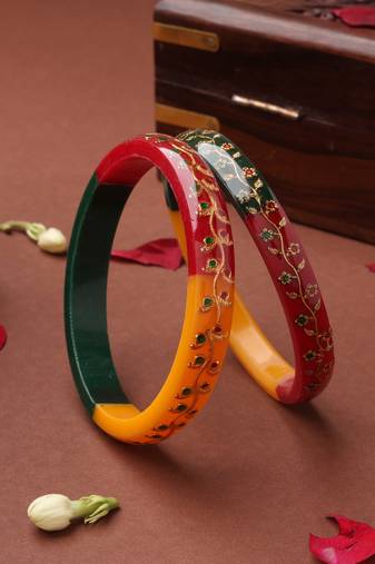 Multicolored bangles with gold embellishments and floral designs