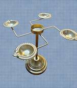 Gold-coloured iron diya stand for pooja