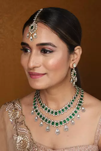 Two-layer necklace set with green stones and american stones, earrings & maang tikka
