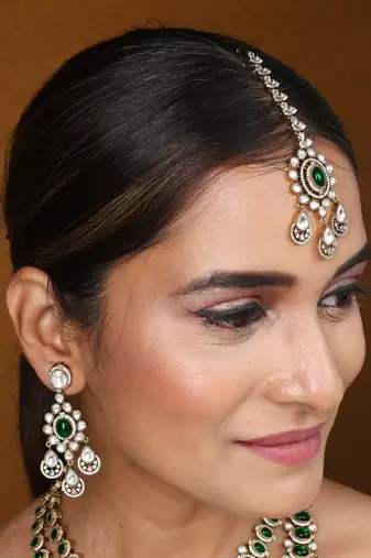 Two-layer necklace set with green stones and american stones, earrings & maang tikka