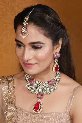 Jaipur jadau work necklace set with red stones, earrings, and maang tikka in kundan