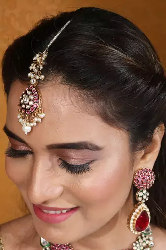 Jaipur jadau work necklace set with red stones, earrings, and maang tikka in kundan