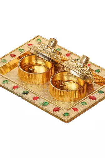 One golden decorative roli chawal holder, akshata haldi kumkum holder